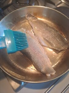 Forellenfilets mit Knoblauchöl einpinseln