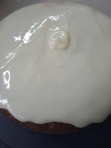 Zuckertopping auf den Kuchen schütten